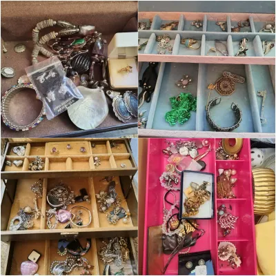 Four jewelry boxes filled with an assortment of vintage costume jewelry, including rings, necklaces, brooches, and earrings.