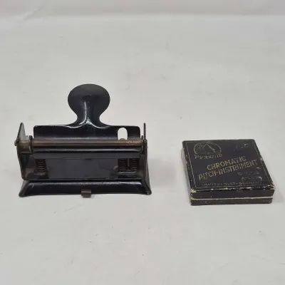 Vintage Desktop Hole Punch And A Chromatic Pitch Instrument 