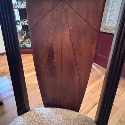 Art Deco style dining chair featuring a fan-patterned wood veneer backrest, dark-stained frame, and a textured beige upholstered seat...