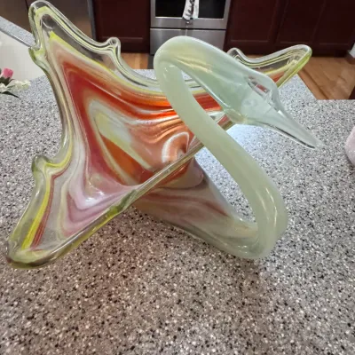 Vintage Murano-style hand-blown art glass swan bowl, featuring a vibrant orange, yellow, and white swirl pattern with a clear green glass...