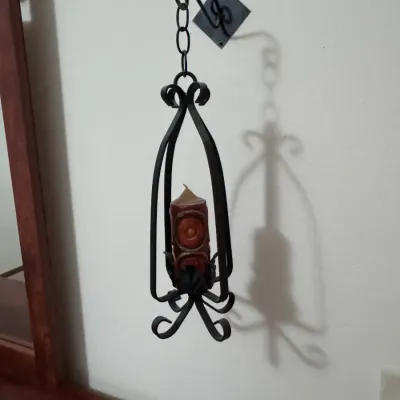 Vintage Spanish Revival wrought iron hanging candle holder sconce, featuring scrollwork details and a wall-mounted bracket, complete with...
