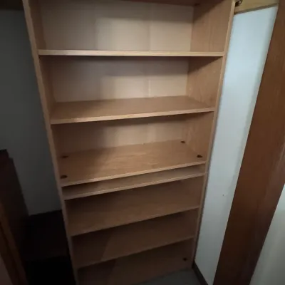 Light oak finish laminate closet shelving unit, featuring six spacious shelves for organization and storage.