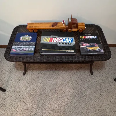 NASCAR memorabilia collection featuring "The NASCAR Vault" and "NASCAR Chronicle" books, alongside a handmade wooden...