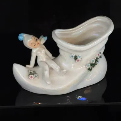 Vintage Lefton ceramic pixie elf shoe planter, model number 50269, made in Japan. This mid-century collectible features a hand-painted...