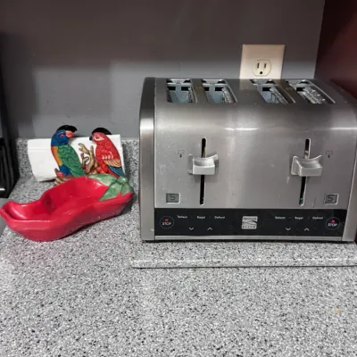 Kenmore Elite 4-slice stainless steel toaster, made in China, featuring digital shade controls and multiple settings, shown alongside a...