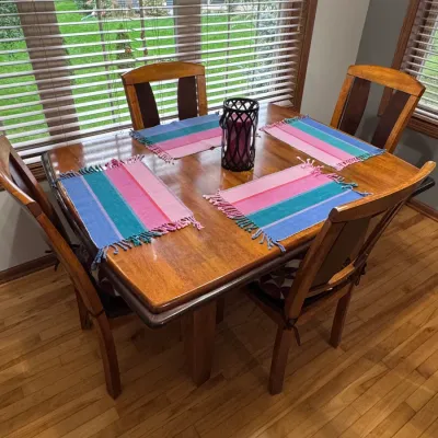Contemporary solid wood dining table and chairs set, featuring a warm honey oak finish, four matching high-back chairs with dark...