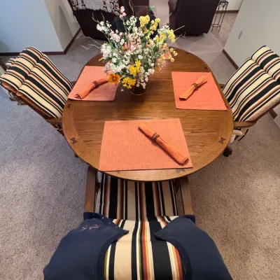Vintage Cochrane Furniture oak dining set featuring a round pedestal table with butterfly leaf extension and four matching caster chairs...