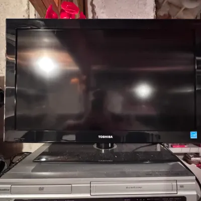 Toshiba flat-screen LCD television, made in China, paired with a GoldStar DVD/VCR combo player, categorized under vintage home electronics.