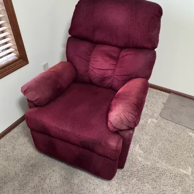 La-Z-Boy burgundy corduroy fabric recliner chair, featuring a plush, cushioned backrest and padded armrests, made in the USA.