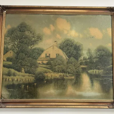 Vintage framed landscape print by George H. Owen, depicting a rustic house by a river with a figure in a rowboat, housed in an ornate...