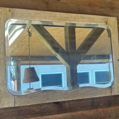 Vintage rectangular wall mirror featuring a beveled glass edge and a rustic, weathered light wood frame.