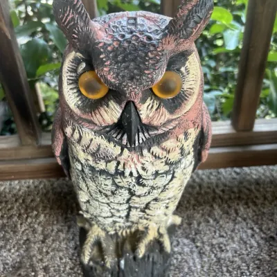 Vintage plastic great horned owl decoy with yellow glass eyes, designed for garden pest control.