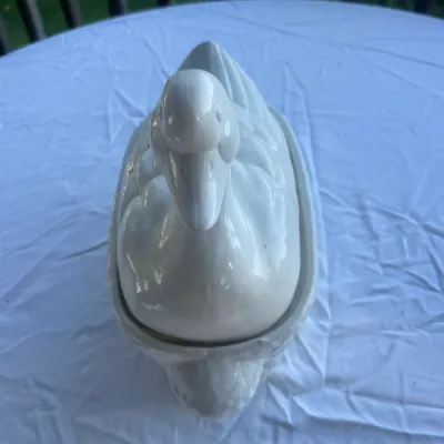 Vintage white ceramic duck tureen with a removable lid, featuring a glossy glaze finish.