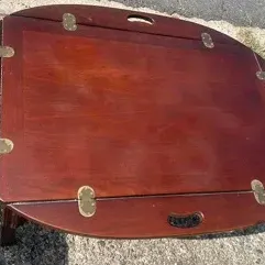 Vintage mahogany butler's tray coffee table featuring drop-leaf sides with brass hinges and integrated handle cutouts.