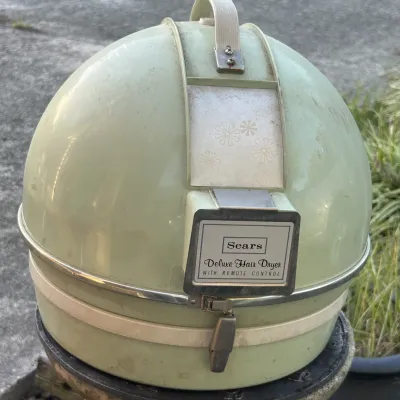 Vintage Sears Deluxe Hair Dryer with remote control, featuring a retro avocado green dome case with floral accents, circa 1970s.