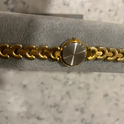 Vintage women's gold-tone link bracelet watch, shown from the back with a stainless steel case back.