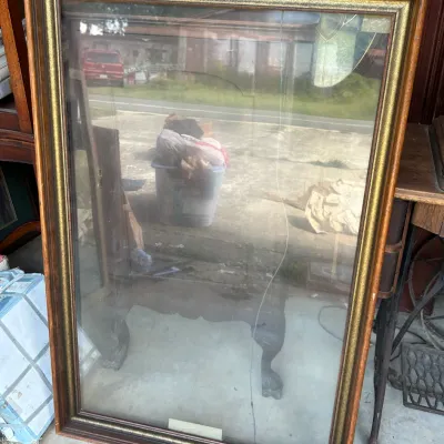 Large rectangular wooden picture frame with a gold-painted inner border and protective glass.