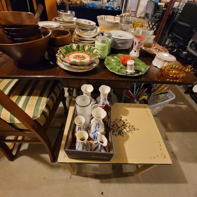 Assorted vintage tableware and home decor items, including wooden bowls, ceramic plates, a green majolica-style egg plate, and a...