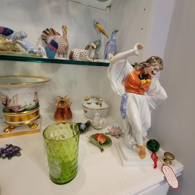 Herend porcelain dancer figurine in traditional attire, displayed alongside a green glass tumbler, a footed porcelain urn, and various...