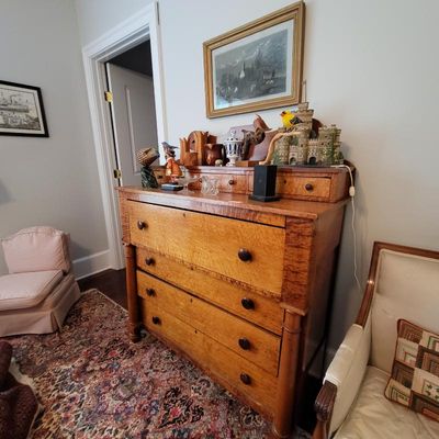 Antique tiger maple chest of drawers featuring a top gallery with small drawers, wooden knobs, and column details, styled with various...