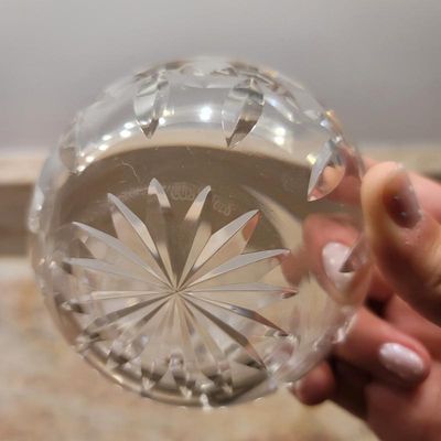Waterford crystal glass piece showing the acid-etched maker's mark on the underside of the starburst-cut base.