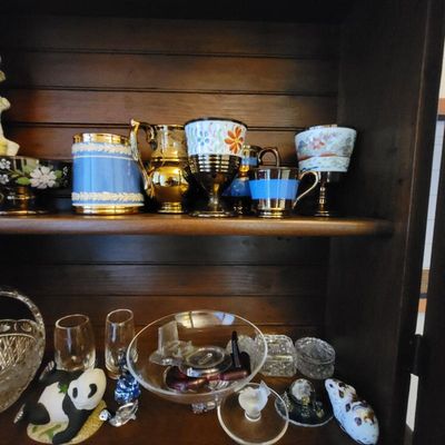 Assorted vintage glassware and porcelain collectibles, including lusterware cups, a Wedgwood-style blue jasperware vessel, and decorative...
