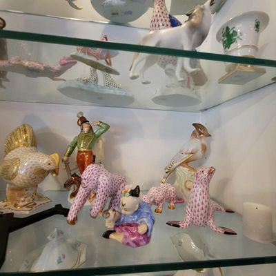 Collection of Herend porcelain figurines, including various animals with the signature fishnet pattern and a hand-painted soldier figure,...