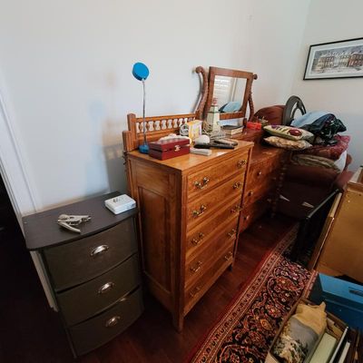 Vintage oak tallboy chest of drawers with brass hardware, shown alongside a matching dresser with mirror and a modern three-drawer...