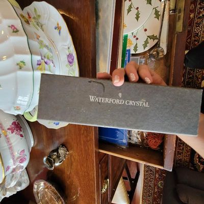 Vintage Waterford Crystal gray presentation box, shown held over a drawer of collectibles and fine china.