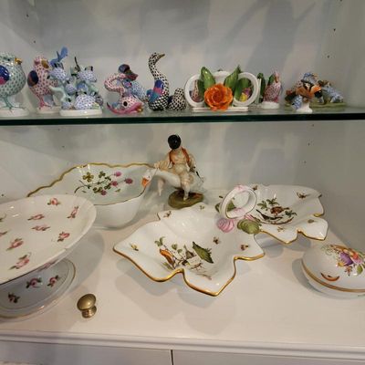 Collection of Herend porcelain figurines and serving dishes, featuring fishnet pattern animals on the top shelf and Rothschild Bird...
