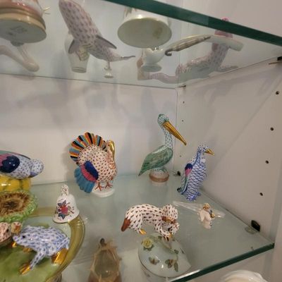 Collection of Herend porcelain figurines, including a turkey, pelican, penguin, and frog, featuring the signature fishnet pattern and...