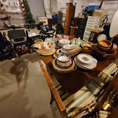 Wooden dining table and chairs set with striped cushions, displayed with an assortment of vintage tableware, ceramic bowls, and wooden...