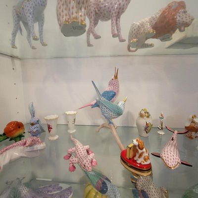 Collection of Herend porcelain figurines, including birds, lizards, and other animals, featuring the signature fishnet pattern and gold...