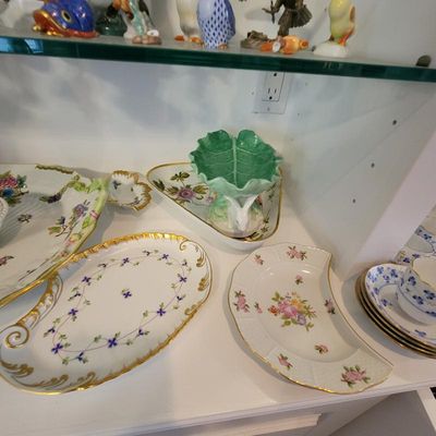 Collection of fine porcelain tableware, including a Herend crescent salad plate, a hand-painted oval dish with gold trim, and a green...