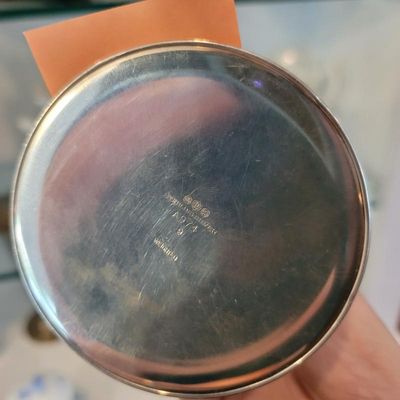 Underside of a weighted sterling silver vessel showing maker's marks, the model number A974, and the "Sterling Silver" stamp.