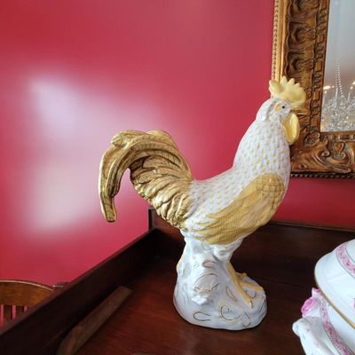 Vintage Italian ceramic rooster figurine with hand-painted gold and yellow details, standing on a wooden surface.