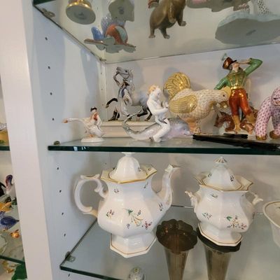 Collection of fine porcelain figurines and tableware, including a Herend-style fishnet rooster, a cherub riding a dolphin, and a...