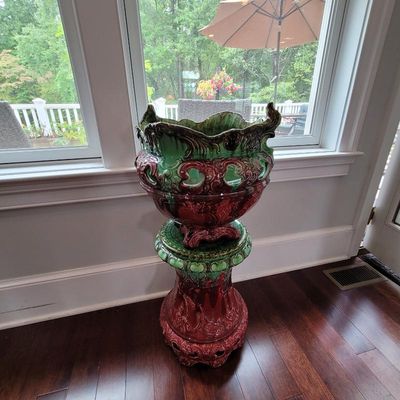 Majolica-style ceramic planter and matching pedestal stand, featuring an ornate relief design with a vibrant green and reddish-brown drip...