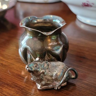 Vintage silver-plated toothpick holder with a ruffled rim, accompanied by a small, detailed silver-plated mouse figurine showing some...