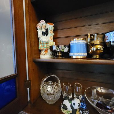Assorted vintage glassware and ceramics, including a Staffordshire-style figurine, a blue jasperware-style mug, and a cut crystal basket,...