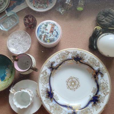 Assortment of vintage porcelain and glass collectibles, including a cobalt blue and gold-gilded decorative plate, a small winter-themed...