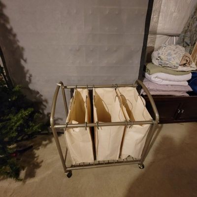 Three-bag rolling laundry sorter with a bronze-finished metal frame and removable canvas bags.