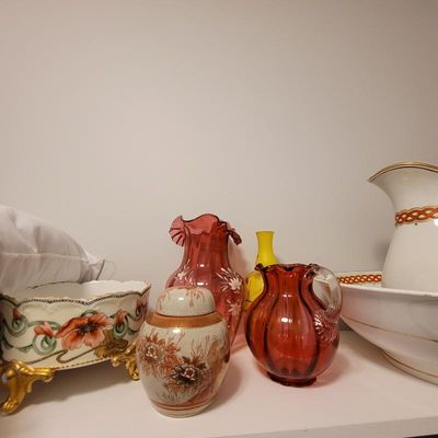 Assortment of vintage glassware and ceramics, including a cranberry glass pitcher, a hand-painted floral footed bowl, and a Satsuma-style...