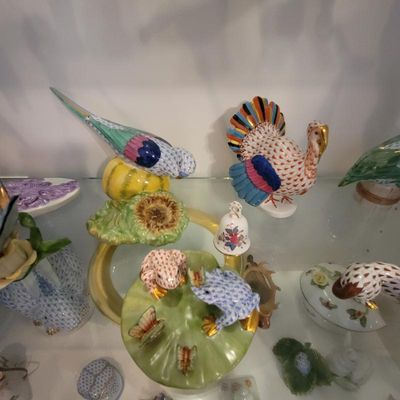Collection of Herend porcelain figurines, including a turkey, a bird perched on a gourd, and frogs on a lily pad, featuring the signature...