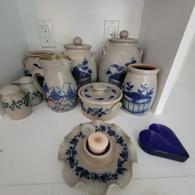 Collection of vintage salt-glazed stoneware kitchenware featuring blue hand-painted designs, including canisters, a pitcher, a butter...