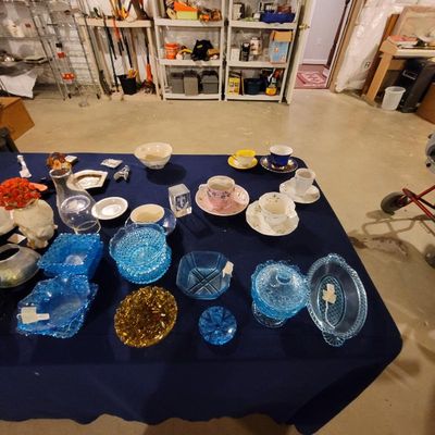 Assortment of vintage glassware and teacups, including blue hobnail and pressed glass bowls, a yellow and amber glass dish, and various...