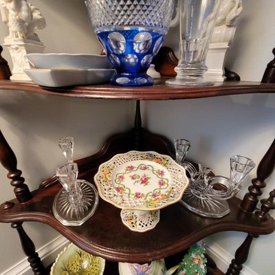 Vintage glassware collection including a cobalt blue cut-to-clear glass vase, crystal candlesticks, and a floral porcelain pedestal dish...