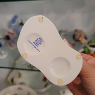 Underside of a Herend Hungary hand-painted porcelain figurine, showing the blue maker's mark, model numbers, and protective felt pads.