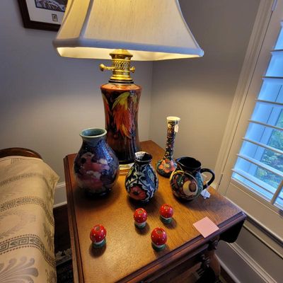 Collection of Moorcroft pottery, including a large table lamp with a cream shade, several floral-patterned vases, a small pitcher, and...