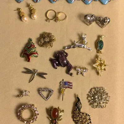 Assorted Costume Jewelry Including Broaches, Rings, And Bracelets